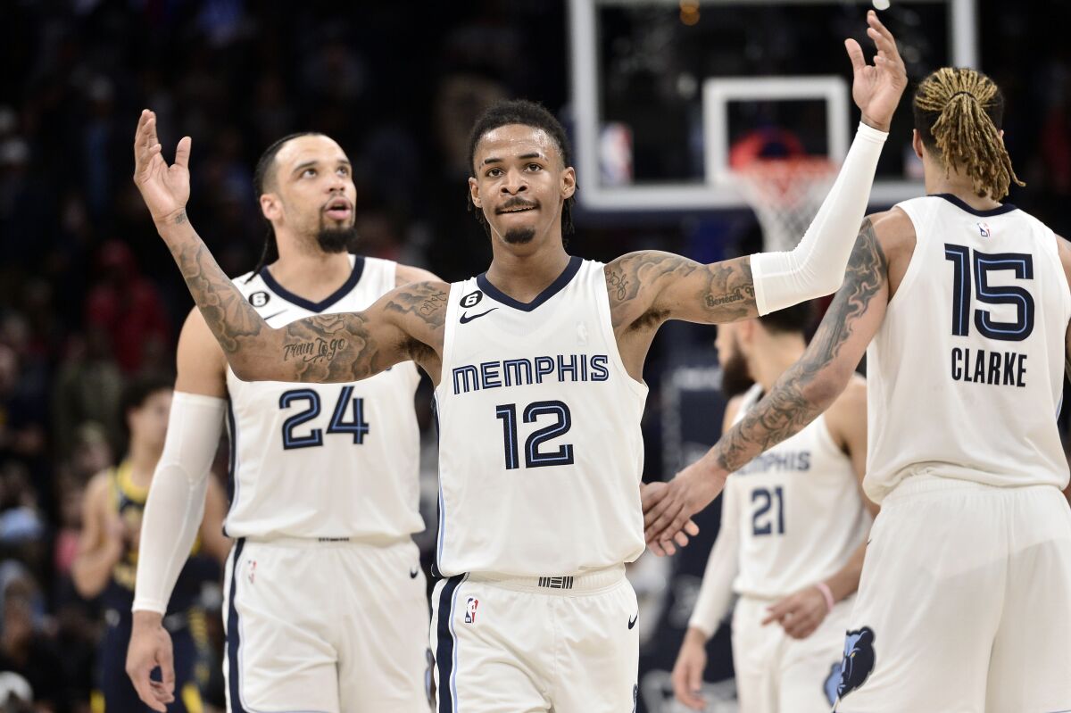 Memphis Grizzlies guard Ja Morant (12) reacts in the second half of an NBA basketball game against the Indiana Pacers, Sunday, Jan. 29, 2023, in Memphis, Tenn. (AP Photo/Brandon Dill)