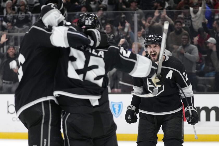 Los Angeles Kings left wing Kevin Fiala, center, celebrates his goal with defenseman Matt Roy, left, and center Phillip Danault during the overtime period of an NHL hockey game against the Chicago Blackhawks Thursday, Nov. 10, 2022, in Los Angeles. (AP Photo/Mark J. Terrill)