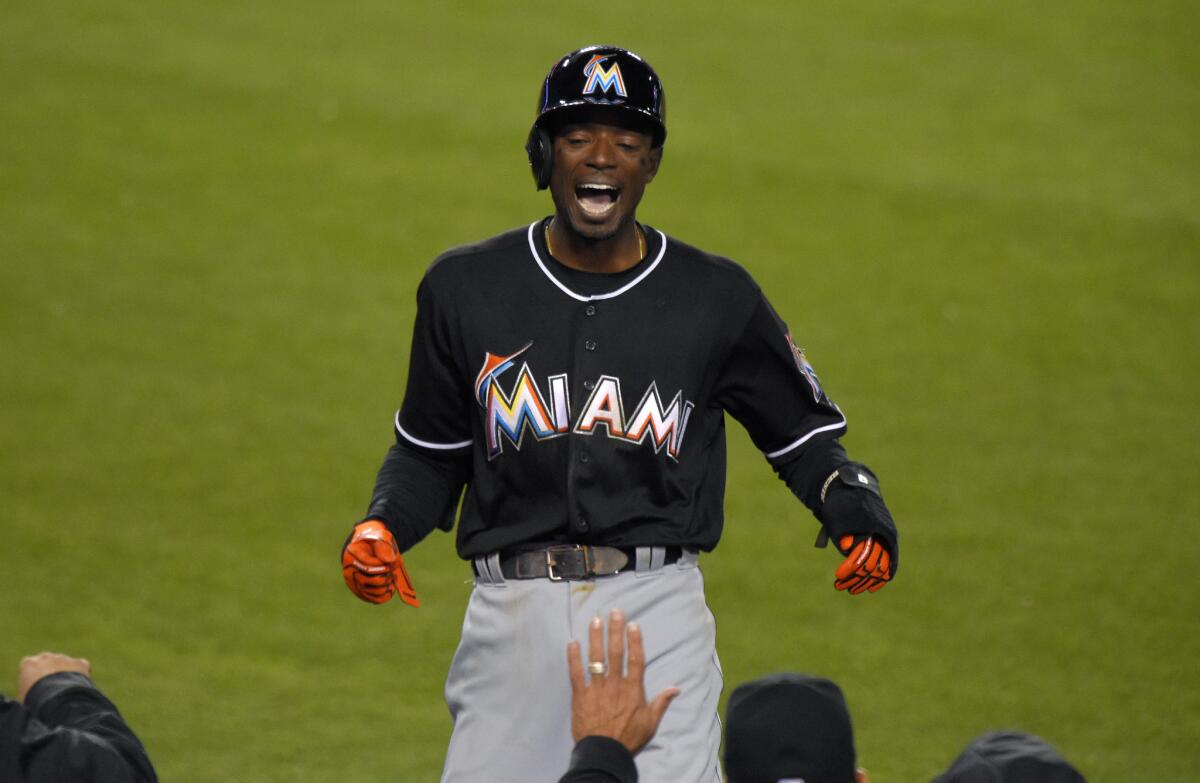 Dee Gordon celebrates after scoring on a balk by Dodgers reliever Pedro Baez on Thursday.