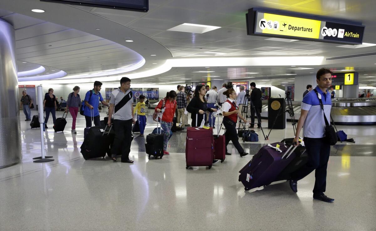 Passengers pull their luggage at Newark Liberty Airport on Monday, in Newark, N.J. An airline organization had suggested smaller sizes of carry-on bags, setting off a furor among consumers and at least one airline organization.