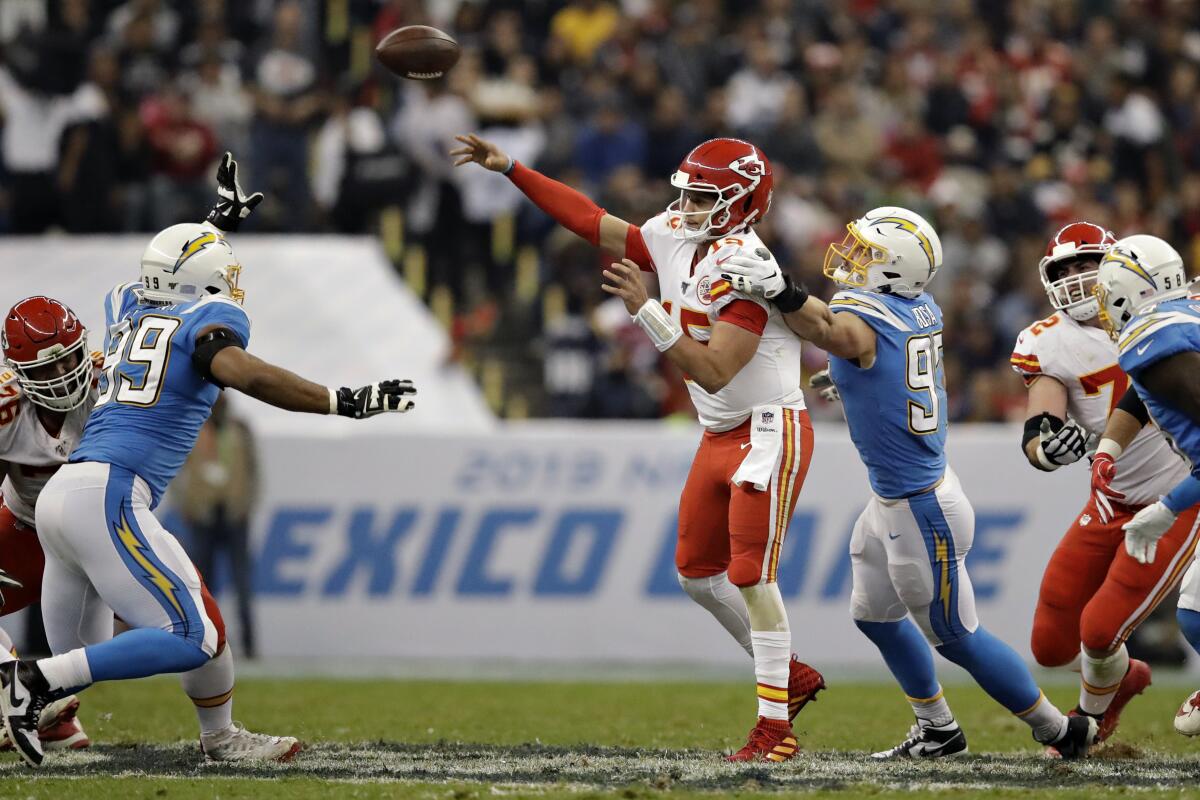 Kansas City Chiefs quarterback Patrick Mahomes throws a pass under pressure from Chargers defensive end Joey Bosa on Nov. 18 in Mexico City.