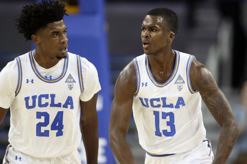 UCLA guard Kris Wilkes, right, celebrates after dunking the ball along with guard Jalen Hill, left, against IPFW during the first half of an NCAA college basketball game Tuesday, Nov. 6, 2018, in Los Angeles. (AP Photo/Danny Moloshok)