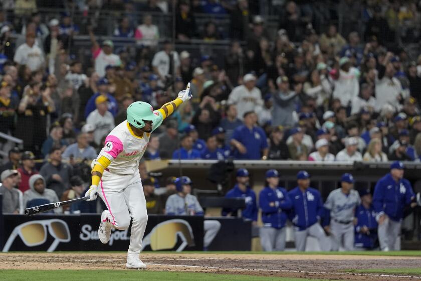 San Diego Padres' Luis Arraez watches his walkoff single during the ninth inning of a baseball game against the Los Angeles Dodgers, Friday, May 10, 2024, in San Diego. The Padres won, 2-1. (AP Photo/Gregory Bull)