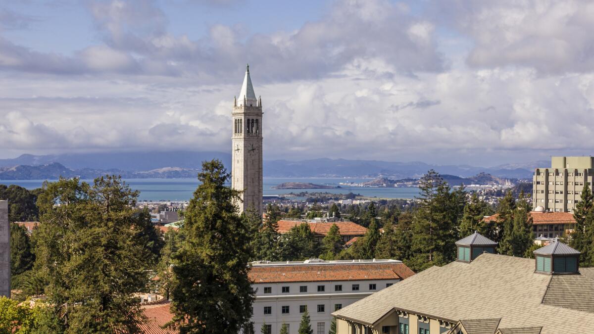 Sather Tower at the UC Berkeley rises above the campus with the San Francisco Bay in the background.