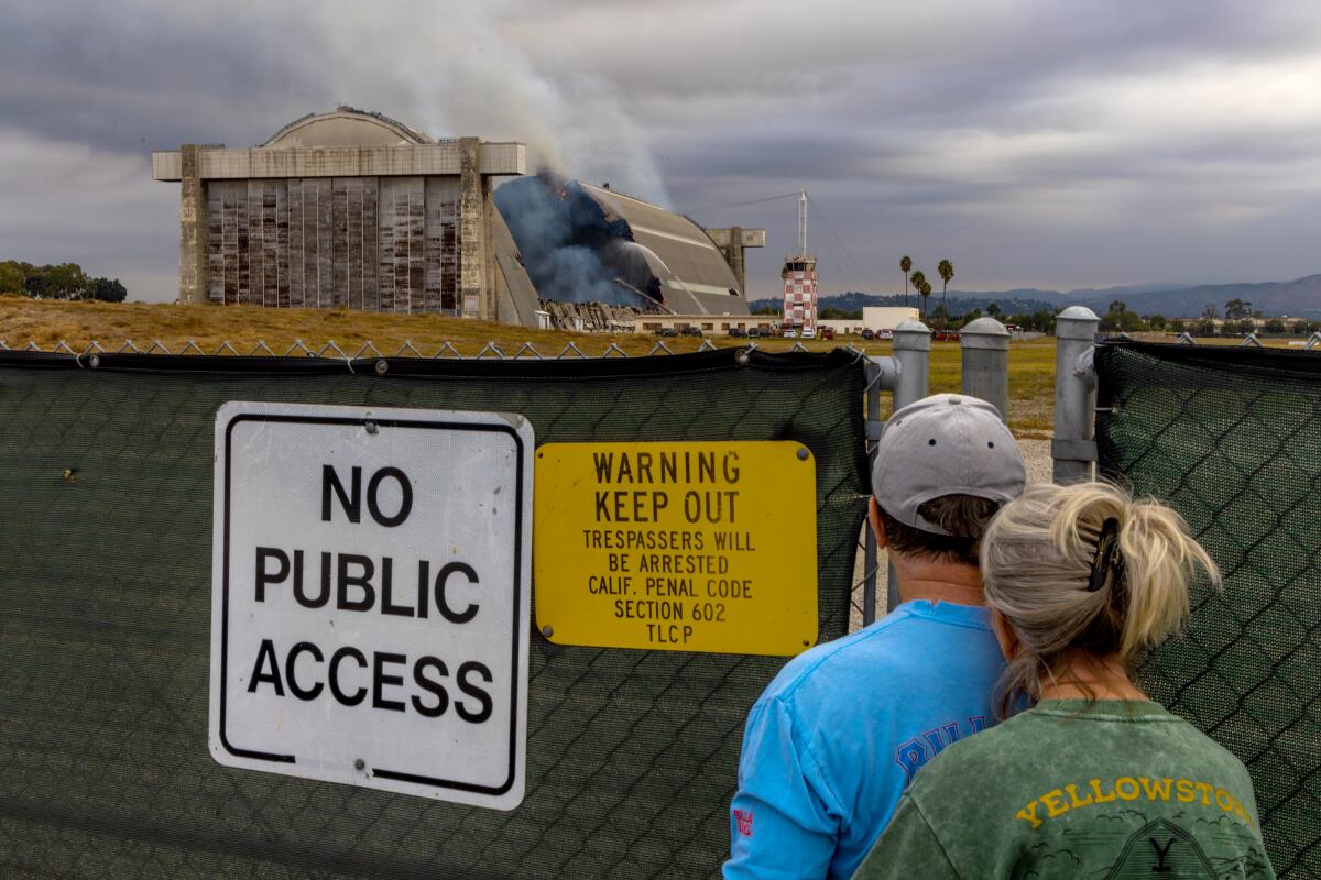 Steve and Patti Craik watch the fire at the former Tustin Air Base in November.