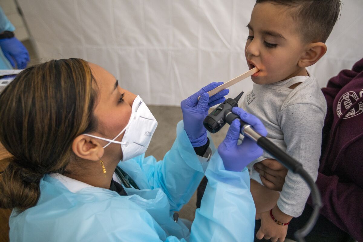 A doctor examines a 2-year-old boy.