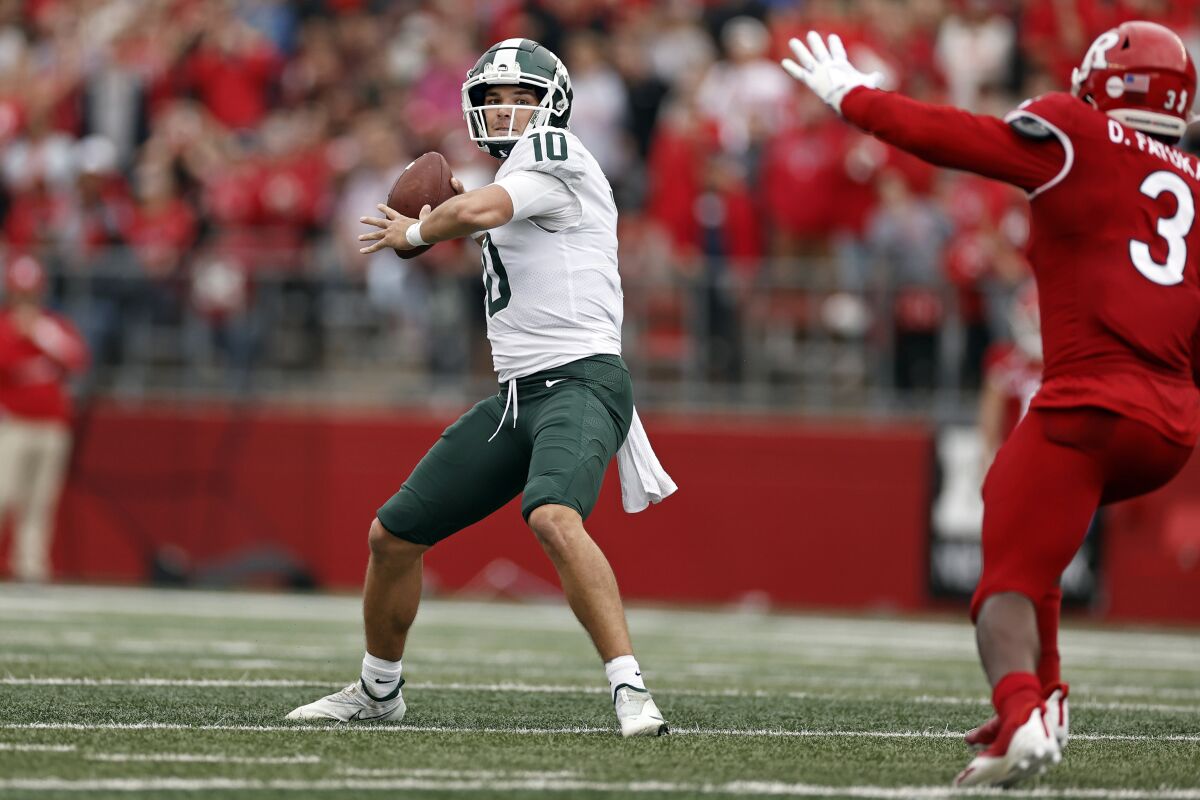 Michigan State quarterback Payton Thorne (10) passes under pressure from Rutgers linebacker Olakunle Fatukasi (3) during the first half of an NCAA college football game Saturday, Oct. 9, 2021, in Piscataway, N.J. (AP Photo/Adam Hunger)