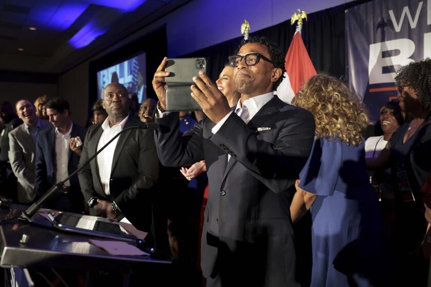 Wesley Bell takes a video of his supporters as he takes the stage as the winner of the Democratic congressional primary against incumbent U.S. Rep. Cori Bush on Tuesday, Aug. 6, 2024, in St. Louis. (Robert Cohen/St. Louis Post-Dispatch via AP)