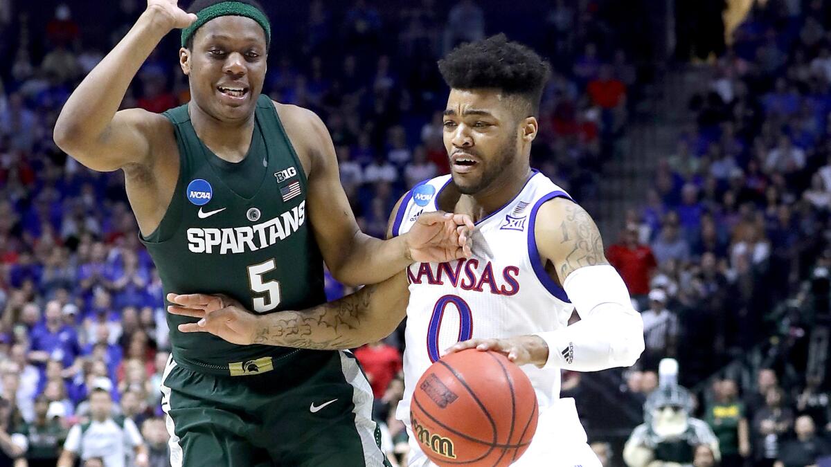 Kansas guard Frank Mason III tries to drive past Michigan State guard Cassius Winston during their NCAA second-round tournament game on March 19.
