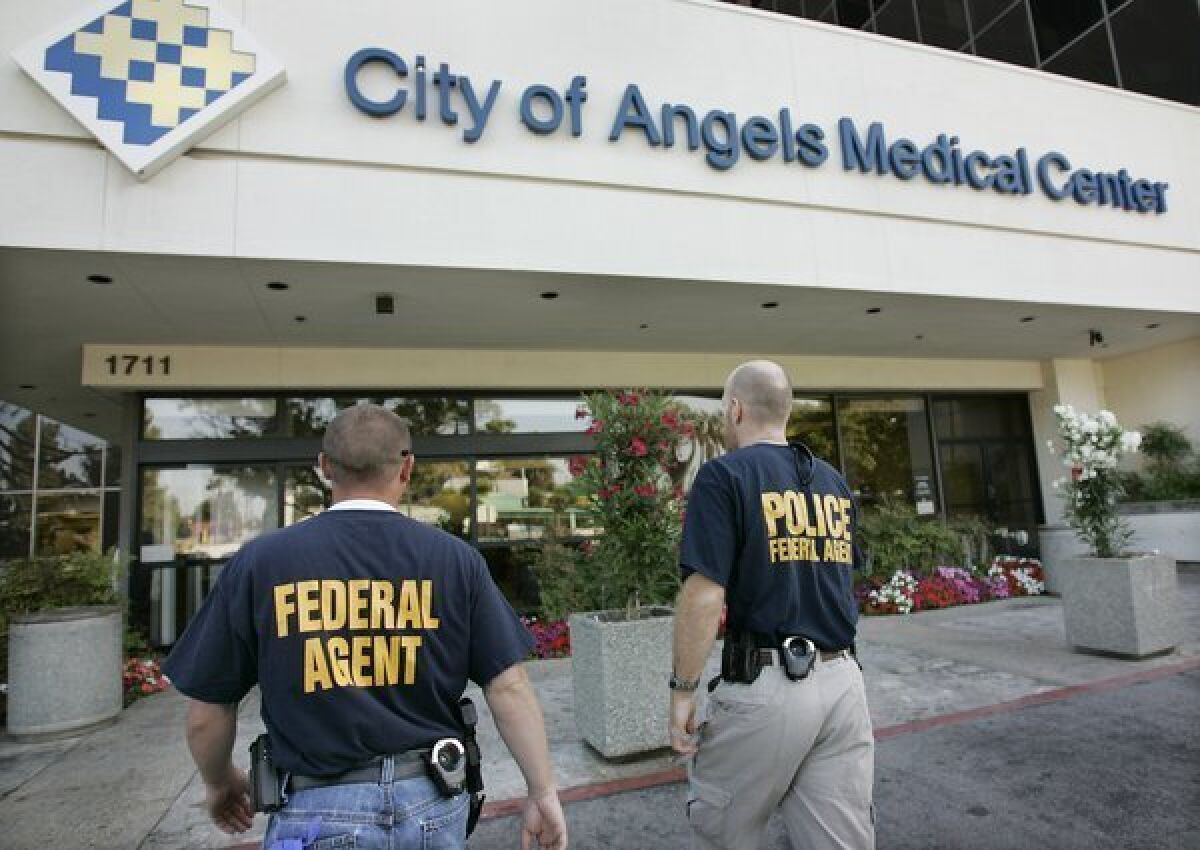 Law enforcement personnel from multiple local and federal agencies enter the City of Angels Medical Center in Los Angeles in 2008 as search warrants were served on it and two other hospitals.