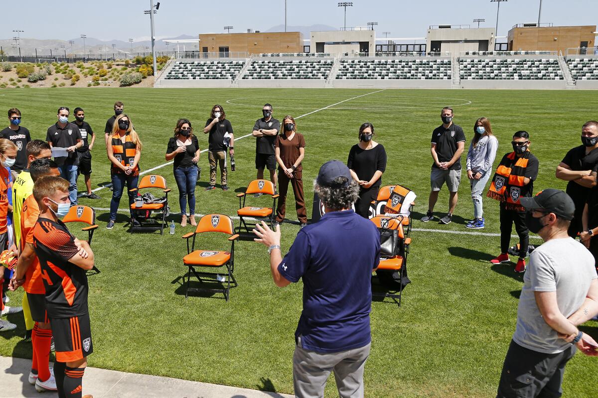 Hoag Hospital healthcare workers and Orange County Soccer Club players listen to instructions for a promotional video.
