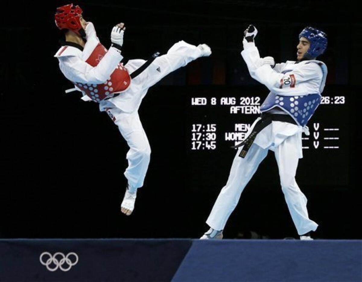 Spain's Joel Gonzalez Bonilla fights Australia's Safwan Khalil (in red) during their quarterfinal match in men's 58-kg taekwondo competition at the 2012 Summer Olympics, Wednesday, Aug. 8, 2012, in London. (AP Photo/Ng Han Guan)