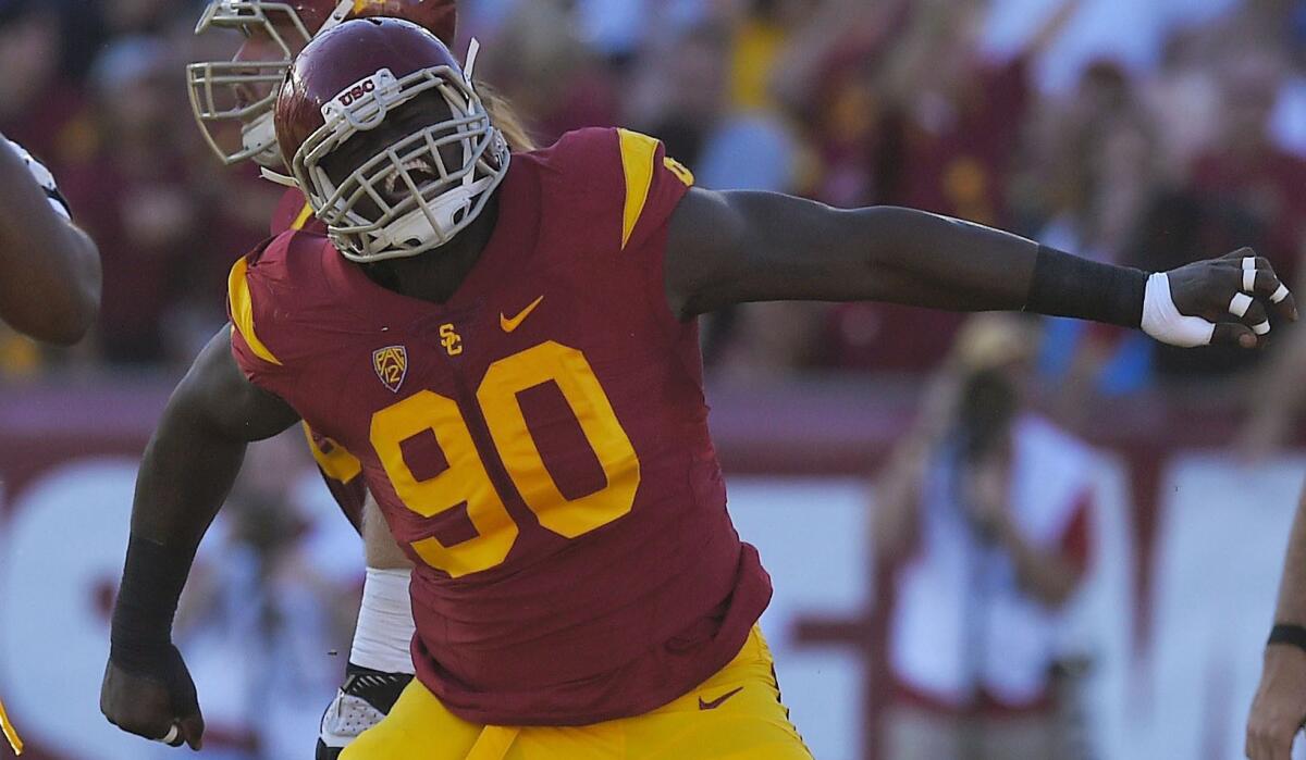 USC defensive end Claude Pelon celebrates after a sack against Stanford at the Coliseum on Sept. 19.