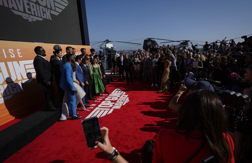 The cast takes a photo.