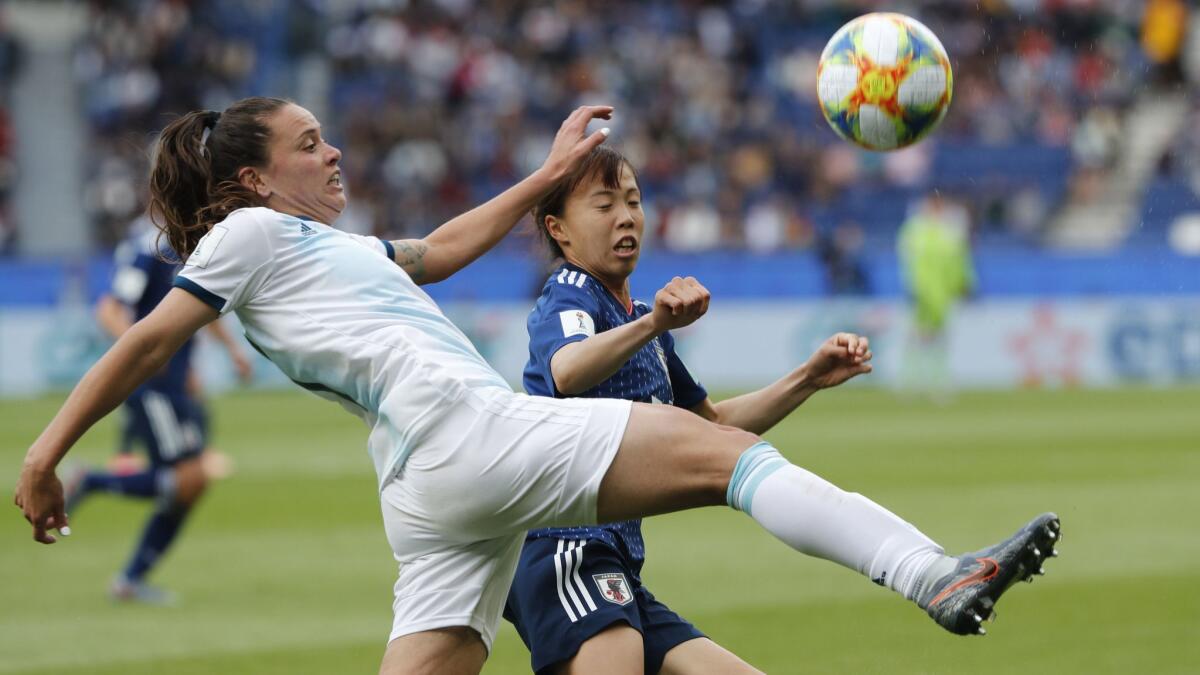 Argentina's Florencia Bonsegundo, left, and Japan's Hina Sugita challenge for the ball during a Women's World Cup Group D match Monday in Paris.