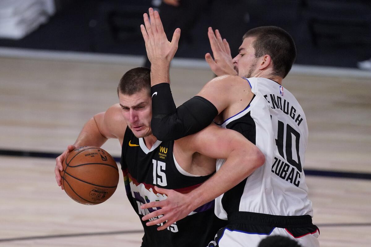 Nuggets center Nikola Jokic tries to power his way past Cippers center Ivica Zubac during Game 3 on Sept. 7, 2020.
