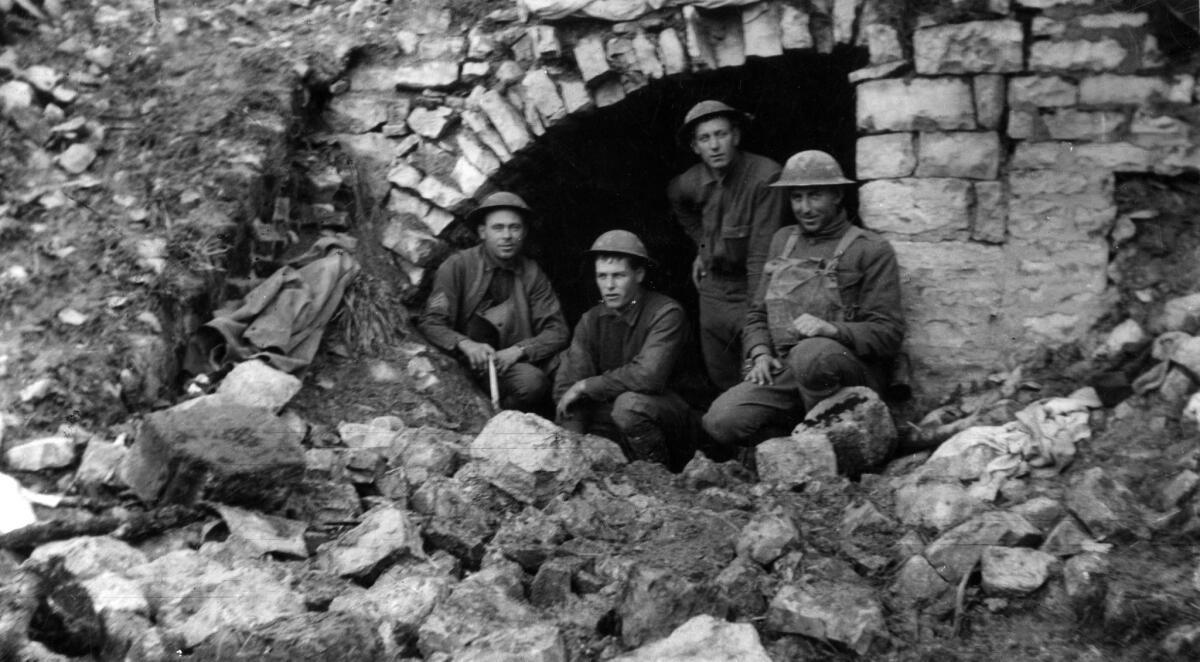 1918: California soldiers with the U.S. Army 91st Division in captured German dugout in Very, France, during the Argonne-Meuse offense. Shortly after this photo was taken two men were killed nearby by shell fire.