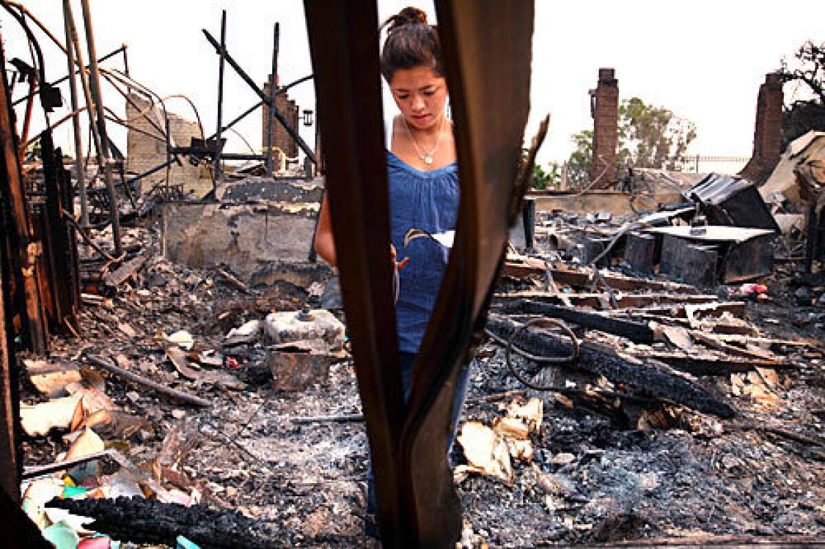 Rachel Whittemore, 17, looks at a child's drawing left in the ruins of the Malibu Presbyterian Church nursery school. Rachel, who attended the preschool as a child, said she cried when she saw it burn down on television. Her mother said bringing Rachel to the ruins was important for her daughter to find "closure."