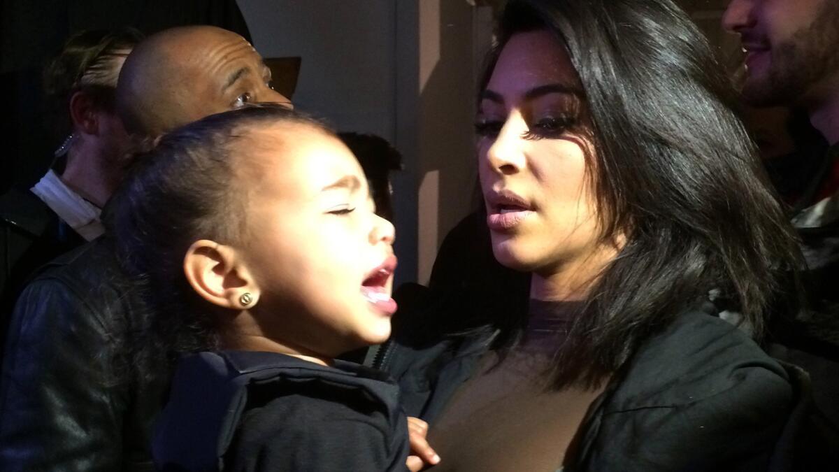 North West seemed to have had enough of fashion by the time she and mommy Kim Kardashian were hanging out after daddy Kanye West debuted his Adidas line Thursday during New York Fashion Week.