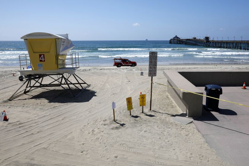 An Imperial Beach lifeguard patrols the beach, which along with the pier which was closed to the public due to the coronavirus on March 29, 2020.
