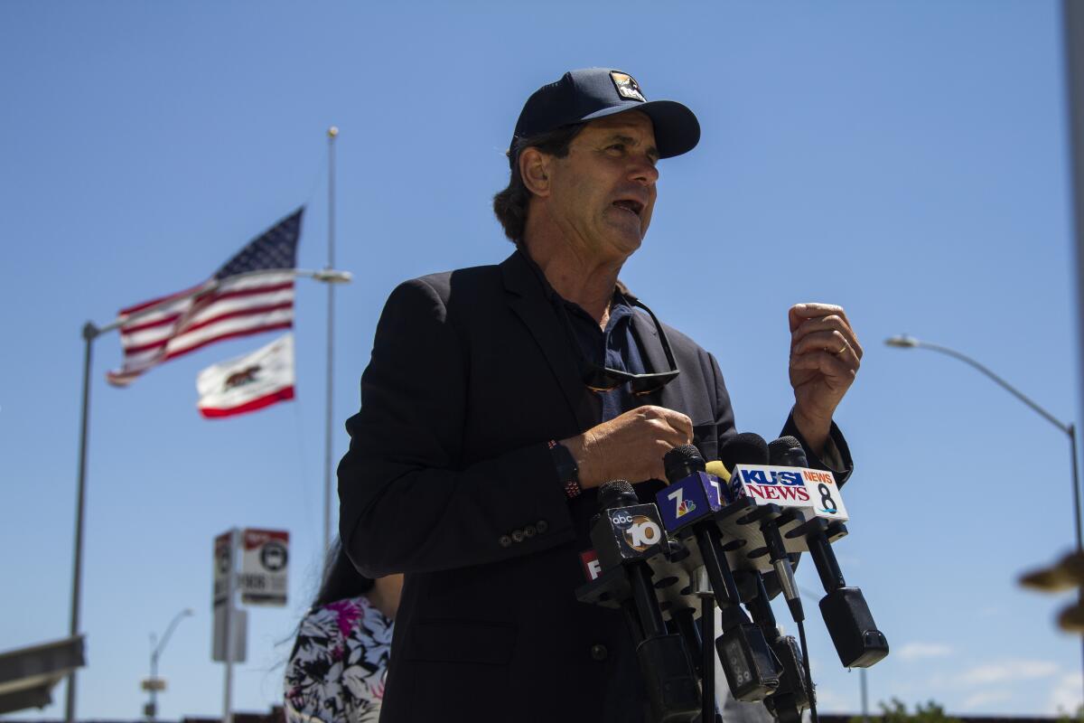 Imperial Beach Mayor Serge Dedina speaks at several microphones