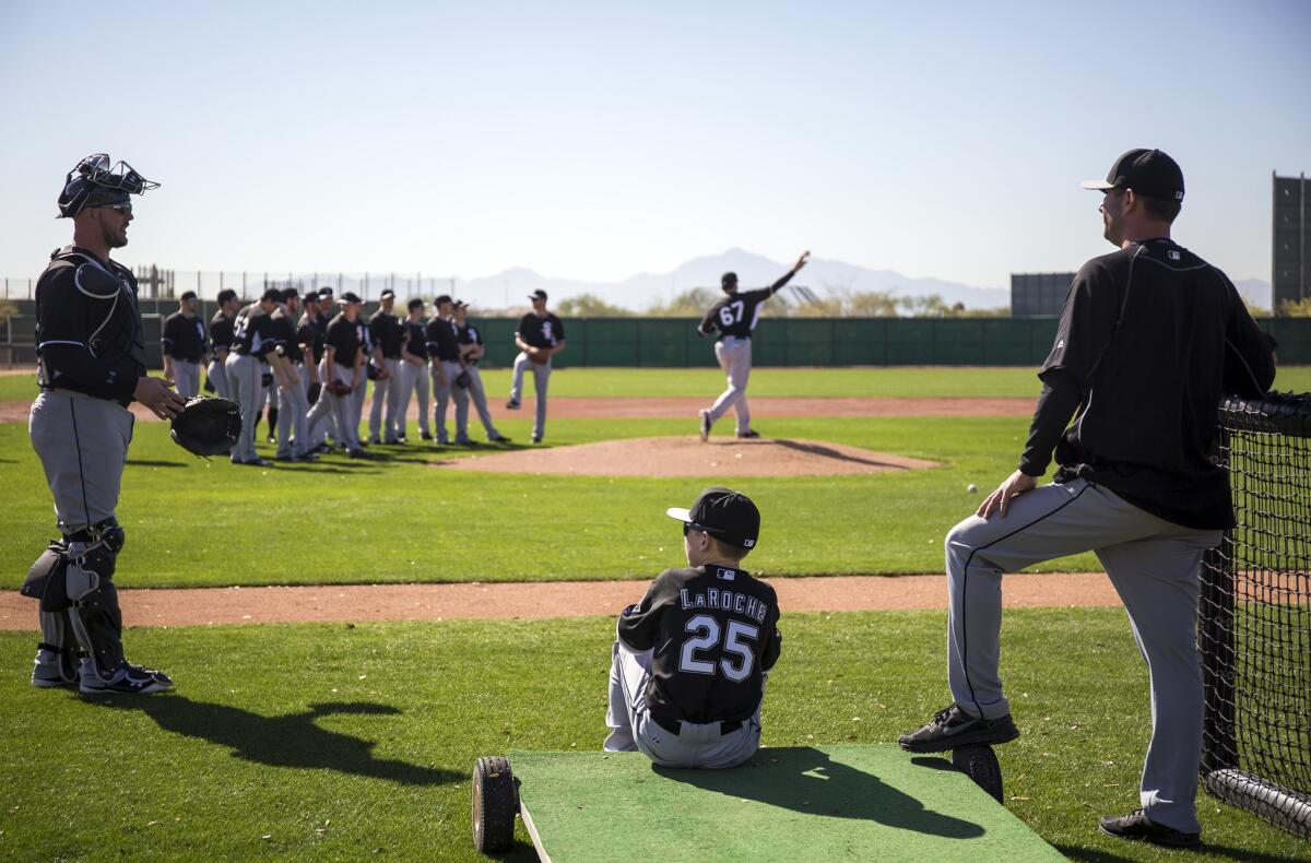 Drake LaRoche, 14, watches the White Sox practice last month.