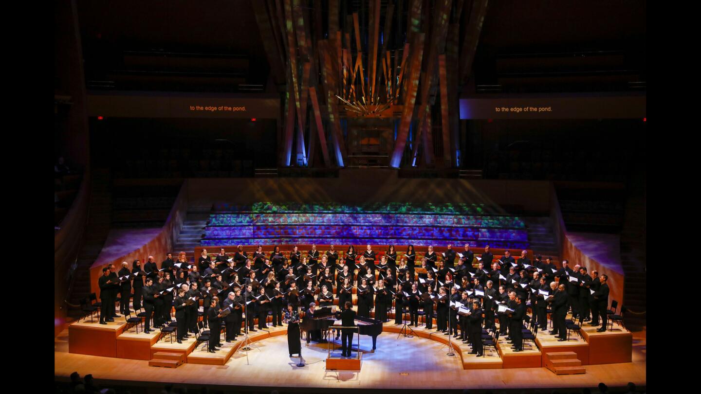 Niké St. Clair, mezzo soprano, sings with the Los Angeles Master Chorale, led by Grant Gershon, as they perform choruses from five John Adams operas at the Walt Disney Concert Hall on March 26 in Los Angeles.