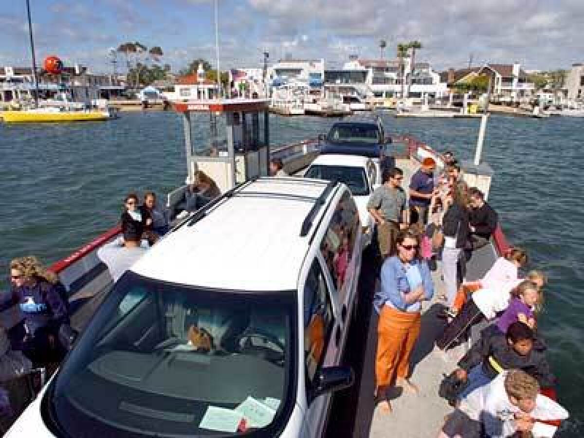 A boat ferries passengers and their vehicles to and from Newport Beach's Balboa Peninsula. The main waterway between the two islands is known as the Grand Canal.