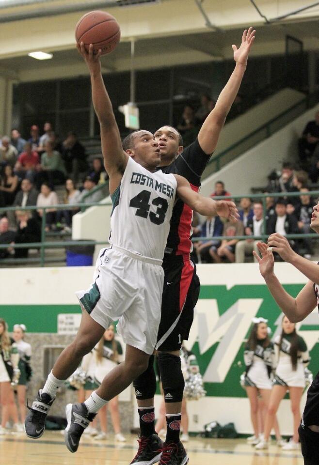 Costa Mesa High's Oronde Crenshaw (43) attempts to score on Harvard-Westlake's Derick Newton during the second half in a CIF-Southern Section Division 4AA first-round game on Wednesday.