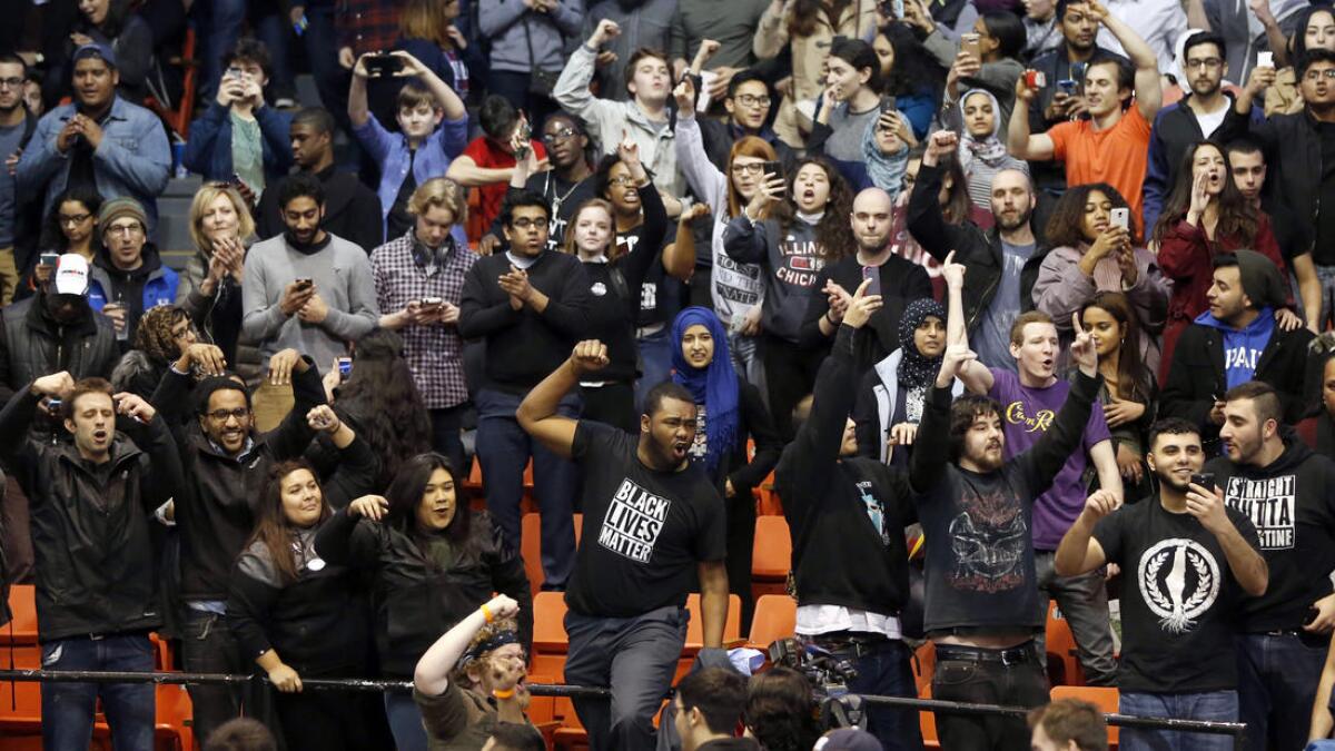 Protesters against Republican presidential candidate Donald Trump chant after it was announced that a rally for Trump was canceled.