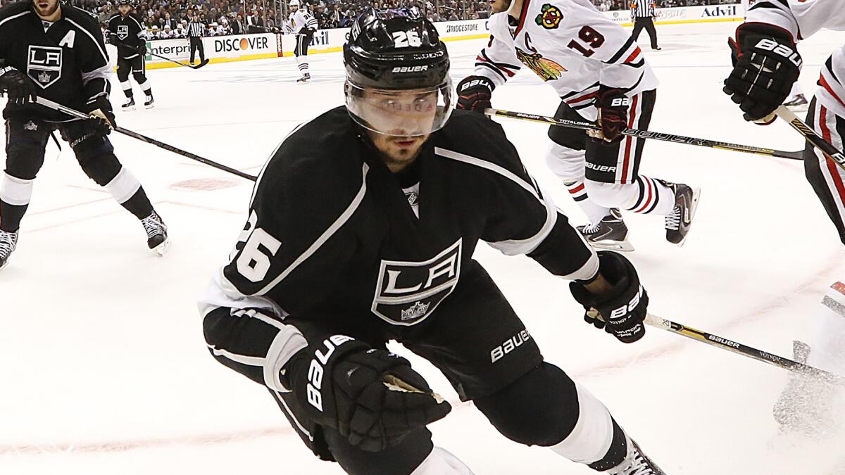 Kings defenseman Slava Voynov chases down a loose puck during a May 26 Western Conference finals game against the Chicago Blackhawks.