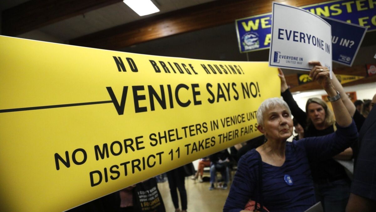 Neighbors both for and against a planned homeless shelter in Venice attend an open house at Westminster Elementary School last June.