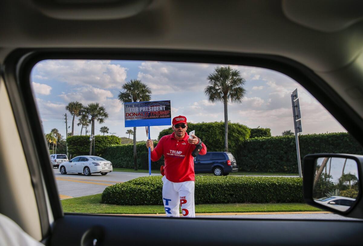 A supporter of Republican presidential candidate Donald Trump stands outside the Mar-a-Lago Club in Palm Beach, Fla. on March 15.