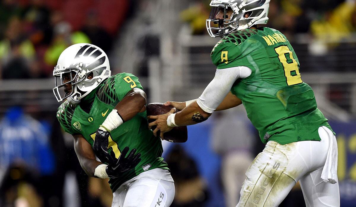With two key offensive players suspended and two others injured, quarterback Marcus Mariota (8) and Oregon will have to rely on Charles Nelson (6) and others to pick up the slack.