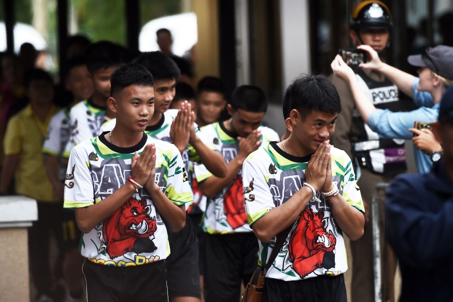 Some of the 12 Thai boys rescued from a flooded cave arrive at a news conference in Chiang Rai on July 18, 2018, following their discharge from the hospital.