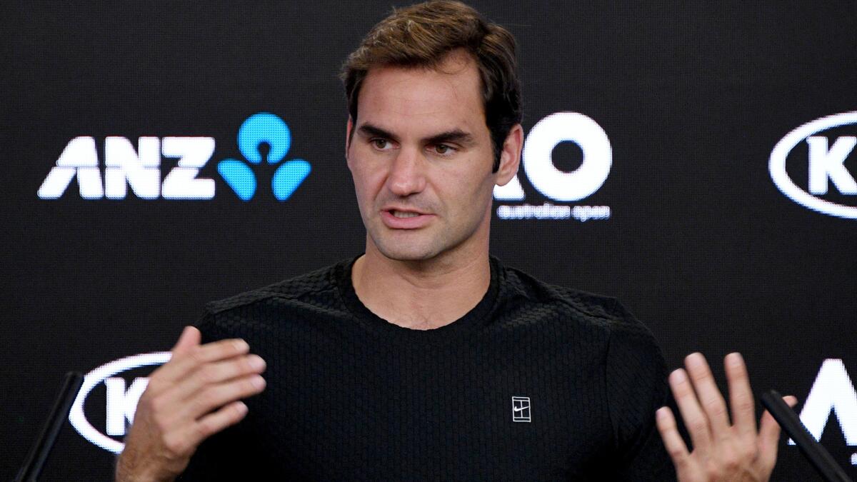 Roger Federer answers a question during a news conference on the eve of the Australian Open.