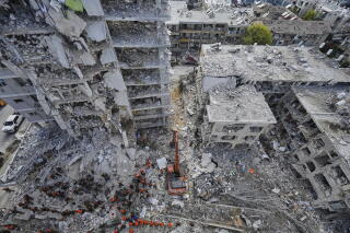 Israeli soldiers search through the rubble of residential buildings destroyed by an Iranian missile strike.