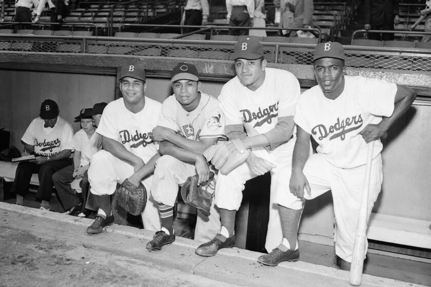 FILE - From left, in a July 12, 1949, file photo, Roy Campanella, Larry Doby, Don Newcombe and Jackie Robinson pose at the 16th annual All-Star Game at Ebbetts Field in Brooklyn, New York. Newcombe, the hard-throwing Brooklyn Dodgers pitcher who was one of the first black players in the major leagues and who went on to win the rookie of the year, Most Valuable Player and Cy Young awards, has died. He was 92. The team confirmed that Newcombe died Tuesday morning, Feb. 19, 2019, after a lengthy illness. (AP Photo/File)