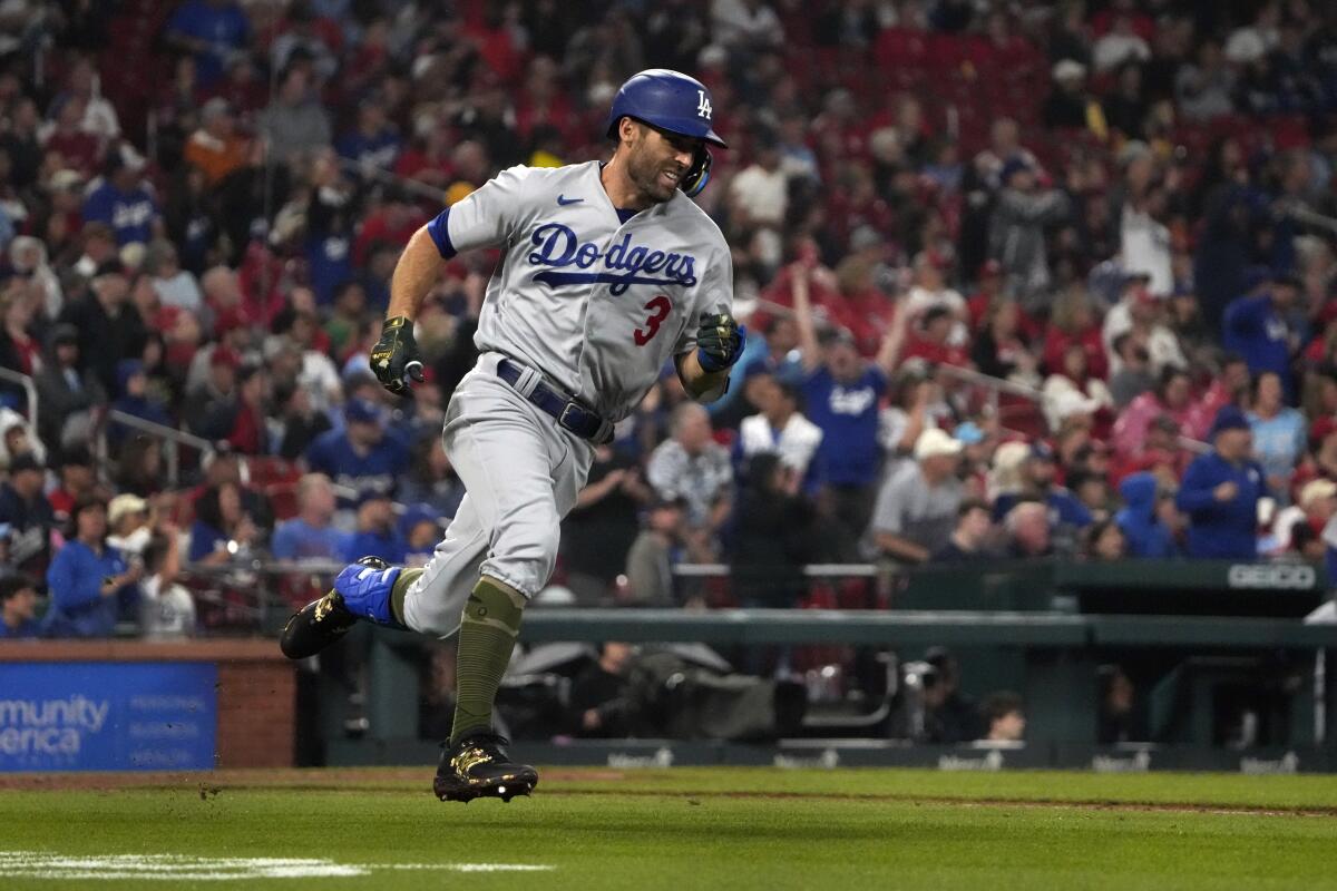 Chris Taylor rounds first after hitting a run-scoring double in the fifth inning for the Dodgers.