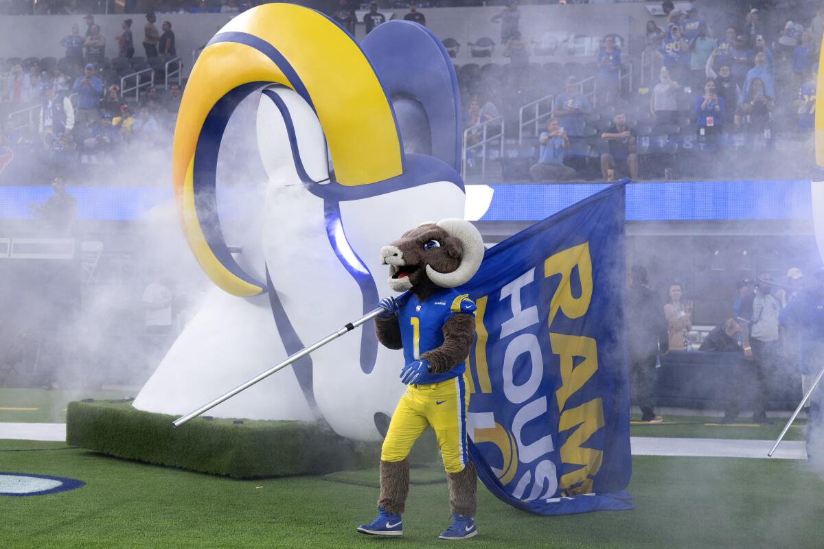 Los Angeles Rams mascot Rampage holds a flag before an NFL preseason football game 