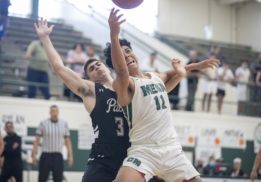 Costa Mesa's Gio Quero goes up for a rebound against Valley Village Valley Torah's Elliott Roessler.