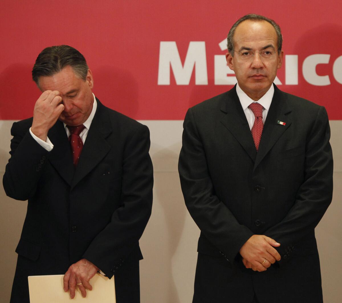 Then-Mexican Atty. Gen. Eduardo Medina Mora, left, and then-President Felipe Calderon at a Sept. 7, 2009, news conference in Mexico City where Calderon announced Medina Mora's resignation.
