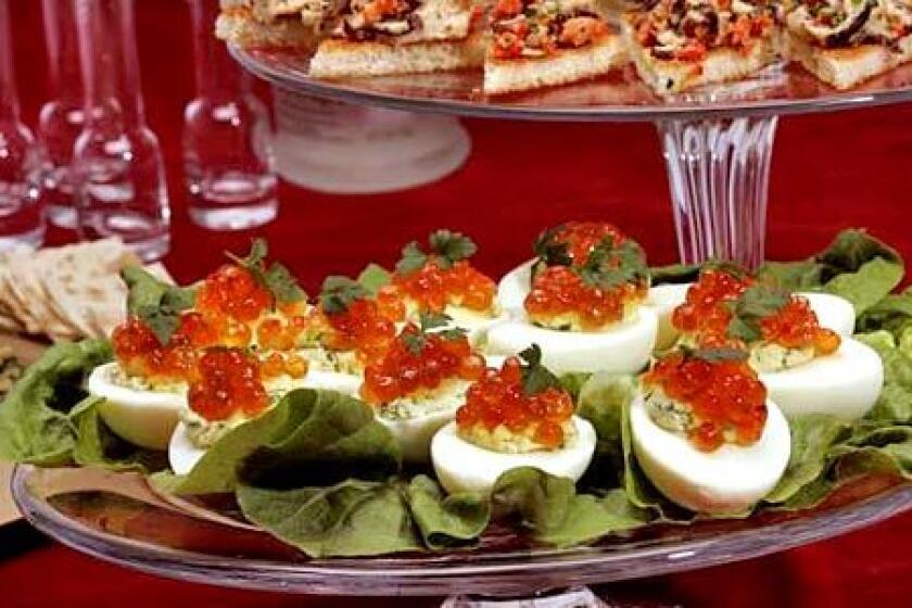 Eggs stuffed with salmon caviar are part of a Russian-style smorgasbord to accompany vodka.