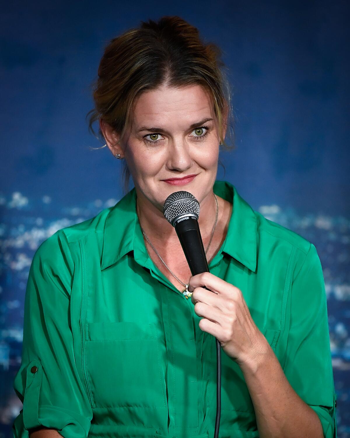 Jen Murphy performing comedy onstage.
