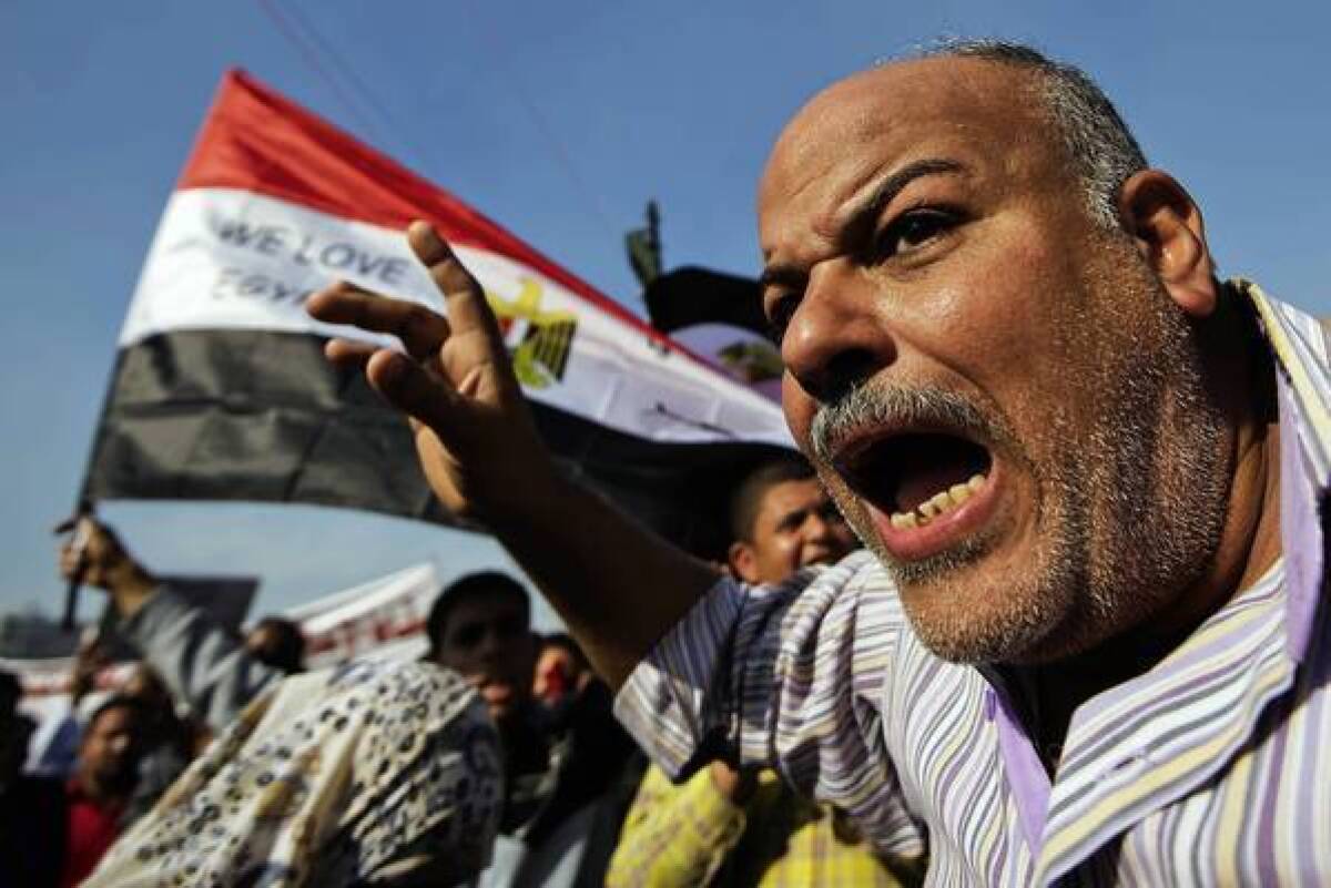 A protester shouts in Cairo's Tahrir Square, where demonstrators denounced the expanded powers of President Mohamed Morsi and the passage of a draft constitution they say doesn't represent all Egyptians.