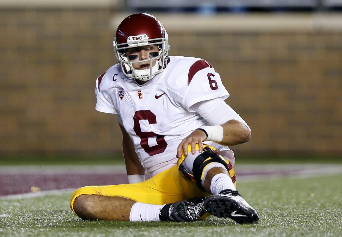 USC quarterback Cody Kessler sits on the turf after being sacked in the first half Saturday against Boston College.