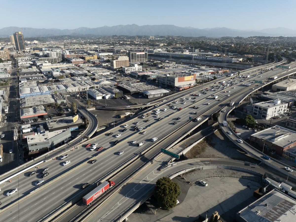 Aerial view of traffic flowing on a freeway through an urban area