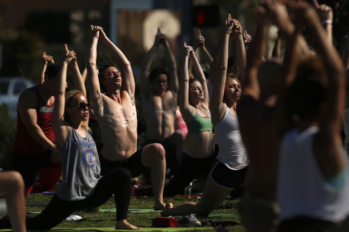 A yoga class takes place on the bluff overlooking the ocean in Bixby Park in Long Beach.