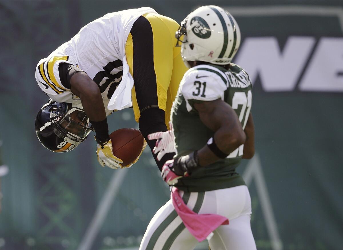 Pittsburgh's Emmanuel Sanders flips into the end zone for a touchdown in front of New York Jets' Antonio Cromartie on Sunday.