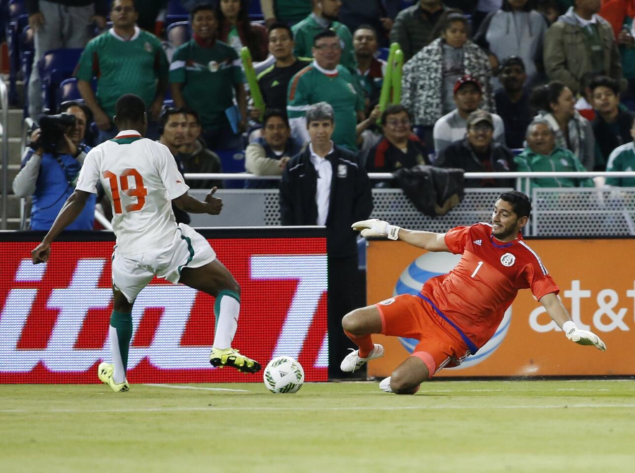Mexico's goalkeeper Jesus Corona (1) makes a save against Senegal's Assane Mbodj during the first half of a soccer match at Marlins Park, Wednesday, Feb. 10, 2016, in Miami. (AP Photo/Wilfredo Lee)